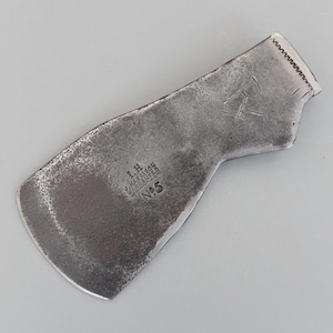 May include: A vintage, weathered metal tool head with a curved blade and a textured surface. The tool has the text "I.H. HARRISON, SHEFFIELD, N°5" and a stylized "R" etched into the metal. The tool's design suggests it is for woodworking.
