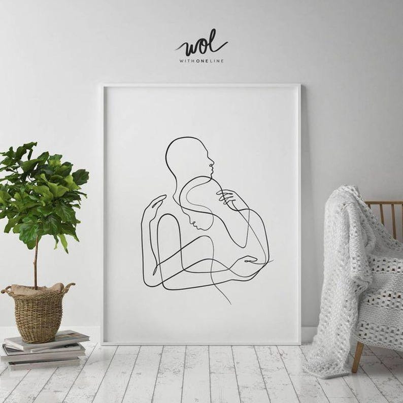 May include: A framed minimalist line art print featuring two figures embracing. The black line drawing depicts a couple in an intimate embrace, set against a white background. The artwork is signed "wol WITHONELINE" in the upper right corner.