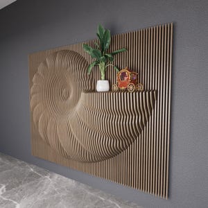 May include: A wooden wall sculpture in the shape of a nautilus shell with a plant and a small carriage on a shelf. The sculpture is made of thin, vertical wooden slats.