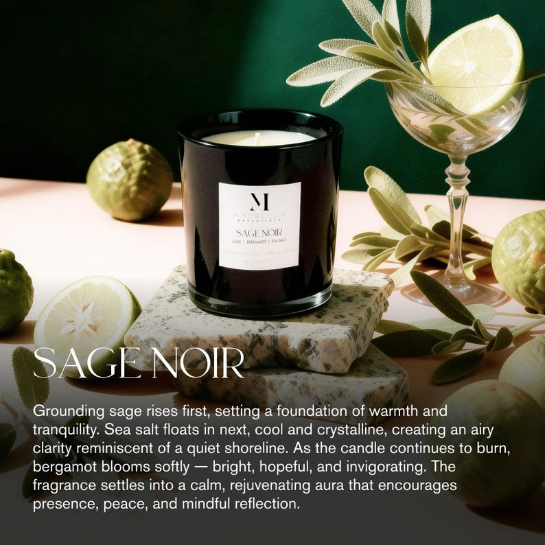 May include: A black glass candle jar labeled "SAGE NOIR" sits on a stone block. The candle has a white label with the letter "M". The image includes a cocktail glass with a lime slice and sage leaves, and green citrus fruits.