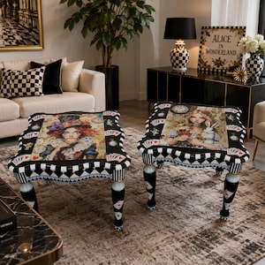 May include: Two square coffee tables featuring black and white checkered trim, playing card motifs, and illustrations of characters from Alice in Wonderland on the tabletops. The tables have black legs with painted card suit details.