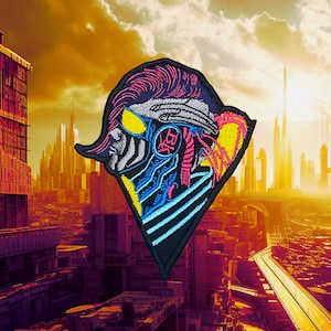 May include: A black, blue, pink and yellow embroidered patch depicting a stylised face with a futuristic design. The patch is diamond-shaped and is set against a backdrop of a city skyline.