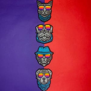 May include: Four embroidered iron-on patches featuring animals wearing sunglasses. The patches are on a purple and red background. The animals include a cat, a pug, a dog, and another pug.
