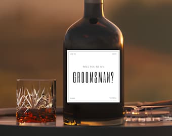 May include: A brown glass bottle with a white label that says "Will you be my groomsman?"  The label also includes the date "Jan 25" and the location "Miami, Florida".