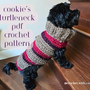 May include: A black dog wearing a striped crocheted turtleneck sweater. The sweater is brown, pink, and purple. The dog is standing on wooden stairs. The text "cookie's turtleneck pdf crochet pattern" is written in pink on a white background. The text "@crochet.with.cookie" is written in black on a brown background.
