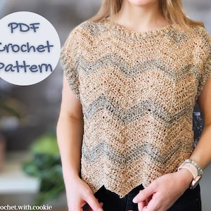 May include: A crochet top with a wavy pattern in beige and green. The top has short sleeves and a scoop neck. The text "PDF Crochet Pattern" is on a white circle with a blue border.
