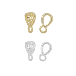 May include: Two pairs of decorative pendant bails, one pair in gold and one pair in silver. Each bail features an intricate, openwork design.