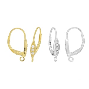May include: Two pairs of earring findings with a clear crystal accent. One pair is gold and the other is silver.
