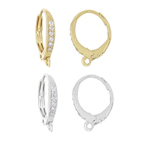 May include: Two pairs of earring findings, one pair is gold with clear cubic zirconia stones and the other pair is silver with clear cubic zirconia stones.