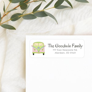 May include: A white rectangular return address label with a green, pink, and blue vintage van illustration. The text "The Goodwin Family" is in black cursive font. The address is "777 East Newcastle Rd. Aberdeen, SD 57401".