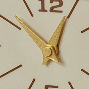 Minimalist mid century clock face with gold hands and brown markers