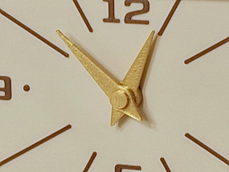 Minimalist mid century clock face with gold hands and brown markers