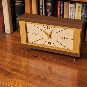 Mid century modern desk clock on bookshelf with vintage decor