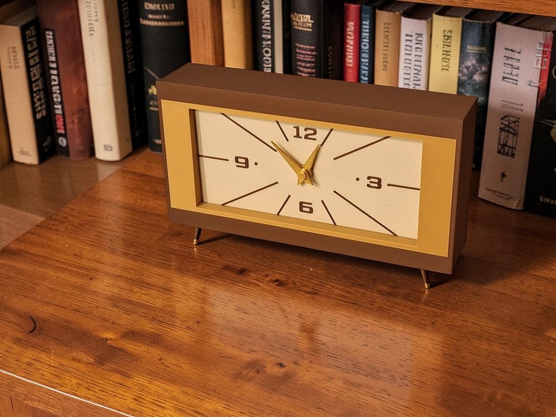 Mid century modern desk clock on bookshelf with vintage decor