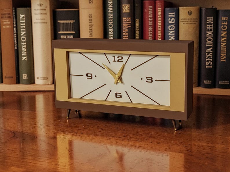 Mid century modern desk clock with brown case and gold legs