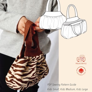 May include: A child holds a small zebra-print bag with a brown handle. The bag is made from fabric with a brown and beige pattern. The image also includes a line drawing of the bag and text that reads "PDF Sewing Pattern Guide" and "Kids Small, Kids Medium, Kids Large".