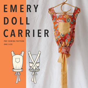 May include: An Emery Doll Carrier PDF sewing pattern in one size. The image features a doll carrier with an orange floral print, a solid yellow pocket, and long yellow ties, hanging on a hanger, alongside two technical line drawings of the design.