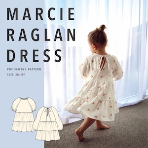 May include: A white long-sleeve dress with a red cherry print, featuring a tiered skirt and a back tie closure. The image includes the text MARCIE RAGLAN DRESS PDF SEWING PATTERN SIZE 3M-8Y and a technical line drawing of the dress design.
