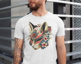 May include: A white t-shirt with a colorful graphic of a fox mask with floral accents. The mask is detailed with red, blue, and gold accents.