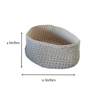May include: A beige crocheted basket with a round shape and a diameter of 11 inches and a height of 4 inches.