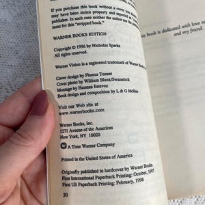 May include: Open book pages with text from "WARNER BOOKS EDITION" copyright 1996 by Nicholas Sparks. The book is dedicated to a friend. The text includes the publisher's address and website.