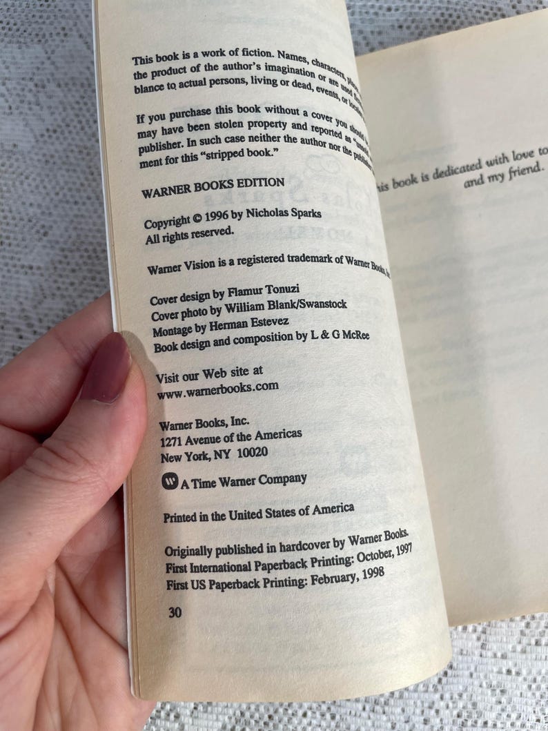 May include: Open book pages with text from "WARNER BOOKS EDITION" copyright 1996 by Nicholas Sparks. The book is dedicated to a friend. The text includes the publisher's address and website.