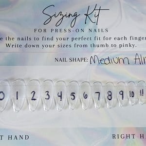 May include: A clear plastic nail sizing kit for press-on nails. The kit includes a row of clear, almond-shaped nail tips numbered 0-11. Text on the card reads "Sizing Kit for Press-On Nails" and "Medium Almond" nail shape.