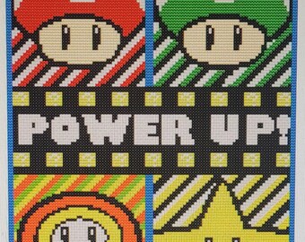 May include: A cross-stitch pattern featuring four iconic video game power-ups: a red mushroom, a green mushroom, a flower, and a star. The pattern is set against a black background with the words "POWER UP!" in white.