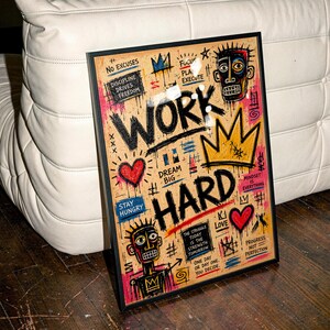 May include: A framed rectangular wall art piece featuring the text WORK HARD in bold black letters. The design includes colorful graffiti-style illustrations, including two stylized faces, crowns, and hearts, with motivational phrases like No Excuses and Dream Big.