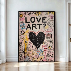 May include: A framed artwork with a black border. The art features a large black heart and the words "LOVE ART?" in bold black letters. The background is a mix of pink, yellow, and white with various doodles and symbols.