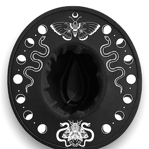 May include: Black felt hat with a white design of a moth, a snake, and crescent moons.