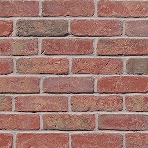 May include: Close-up of a brick wall. The bricks are primarily red with variations of brown and gray. The mortar between the bricks is a light gray color. The bricks are rectangular and arranged in a staggered pattern.