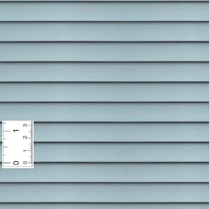 May include: A close-up of light blue horizontal siding with a ruler showing measurements in inches. The siding has a wood grain texture and is evenly spaced. The ruler shows measurements up to 3 inches.
