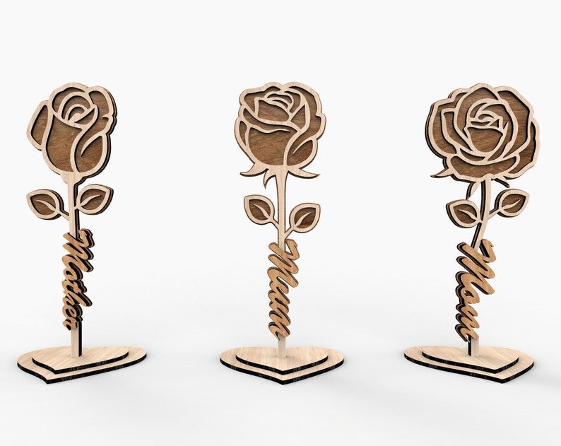 May include: Three wooden rose cutouts with the word "Mom" written on the stem of each rose. The roses are standing on heart-shaped bases.