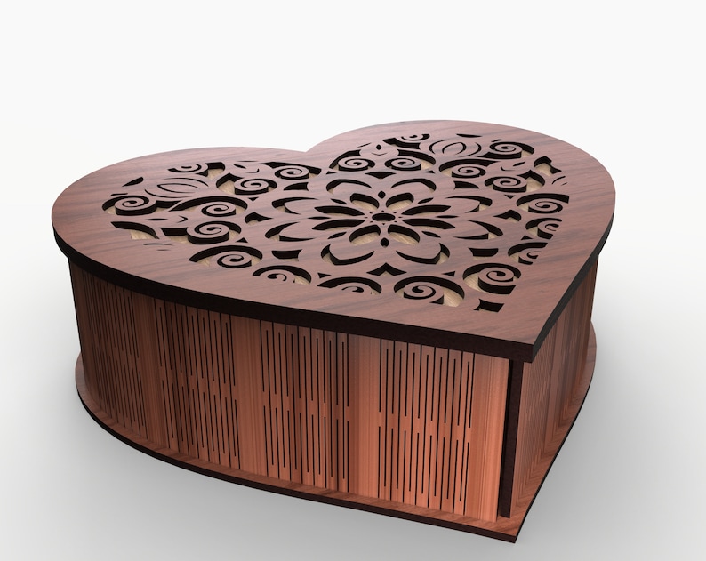 May include: A heart-shaped wooden box with a delicate, intricate laser-cut design on the lid. The box is made of dark brown wood and has a smooth finish.
