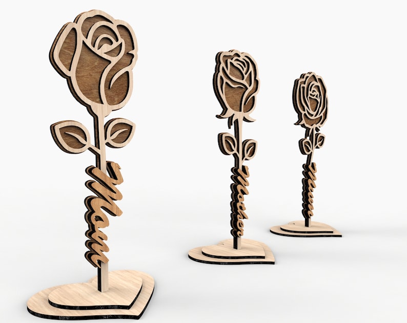 May include: Three wooden rose stands with the word "Mom" carved into the stem. Each stand is shaped like a heart.