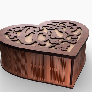 May include: A wooden heart-shaped box with a cutout design of the word "love" and floral accents. The box is closed and sitting on a white surface.