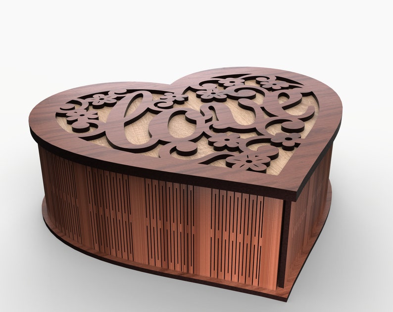 May include: A wooden heart-shaped box with a cutout design of the word "love" and floral accents. The box is closed and sitting on a white surface.
