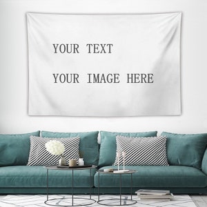 May include: A white tapestry with the text "YOUR TEXT" and "YOUR IMAGE HERE" printed on it. The tapestry is hanging on a white wall above a teal sofa with black and white striped pillows.