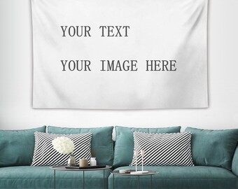May include: A white tapestry with the text "YOUR TEXT" and "YOUR IMAGE HERE" printed on it. The tapestry is hanging on a white wall above a teal sofa with black and white striped pillows.