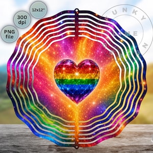 May include: A circular wind spinner featuring a vibrant rainbow-colored heart at its center, surrounded by concentric wavy rings in a galaxy-inspired pattern of orange, purple, and blue. The design includes text labels for 12x12 inches and 300 dpi.