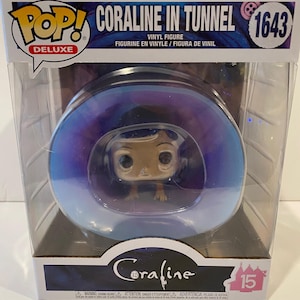 May include: A Funko Pop! Deluxe vinyl figure of Coraline from the movie Coraline. The figure is in a clear plastic box with a purple and blue background. The figure is in a tunnel with a blue and white swirl design. The box has the text "Coraline in Tunnel" and "1643" on it.