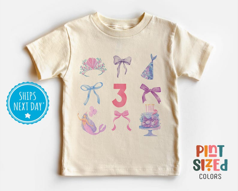 May include: A light beige t-shirt with a pink number 3 and watercolor illustrations of a mermaid, a crown, bows, a party hat, and a birthday cake. The text "Pint Sized Colors" is in the bottom right corner.