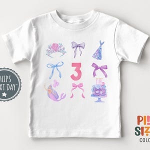 May include: White t-shirt with a pink number 3, a mermaid, a crown, bows, a party hat, and a birthday cake with candles. The text "Print Sized Colors" is on the bottom right corner of the shirt.