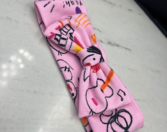 Pink headbands with black drawings