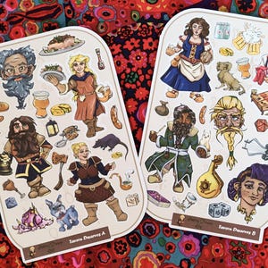 May include: Two sets of stickers featuring illustrations of fantasy characters and objects. The stickers are on a white background with the text "Tavern Dwarves A" and "Tavern Dwarves B".