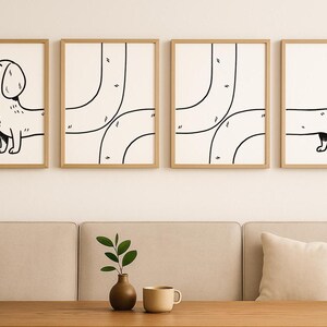 May include: Four framed art prints with a minimalist design. Two prints feature abstract black lines on a cream background. The other two depict a black and white dachshund dog illustration. The frames are a light wood colour.