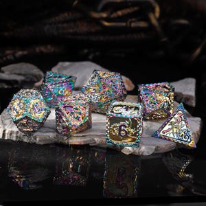 May include: Set of seven iridescent metal dice with a dragon design and gold accents. The dice are numbered 1 through 6 and are perfect for tabletop gaming.