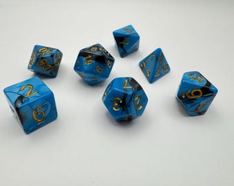 May include: A set of seven blue and black dice with gold numbers. The dice are made of a translucent material with a swirling pattern.