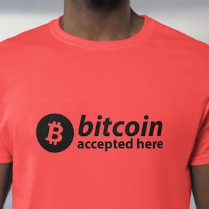 May include: A red t-shirt with a black Bitcoin logo and the text "bitcoin accepted here".